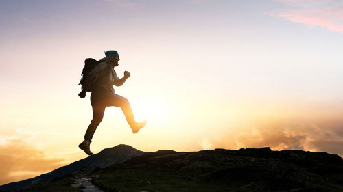 Male backpacker walking in mountains