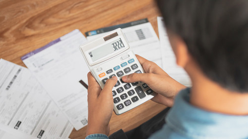 Top view man sitting on the floor stressed and confused by calcu