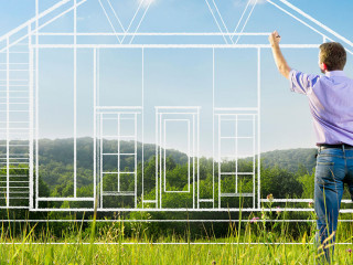 Man drawing a house blueprint in nature