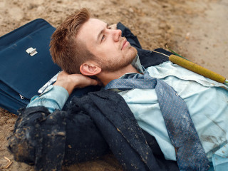 Office worker resting on the beach, desert island