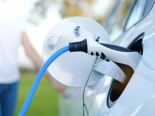 Electric car or ev is charging at station . man use the white po