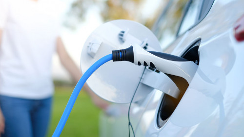 Electric car or ev is charging at station . man use the white po