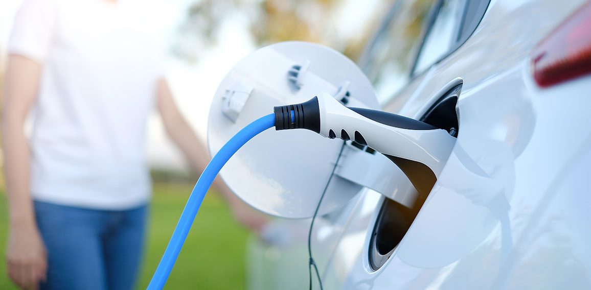 Electric car or ev is charging at station . man use the white po