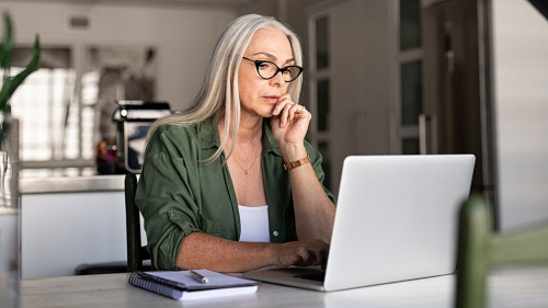 Worried senior woman using laptop