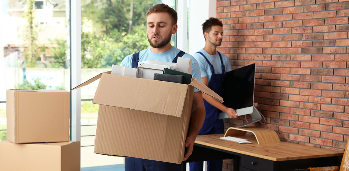 Professional workers carrying stuff out of office. Moving servic