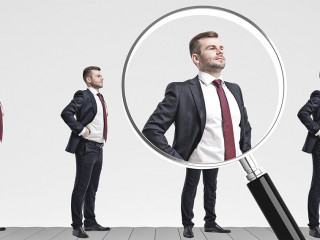 Businessmen on conveyor, magnifying glass