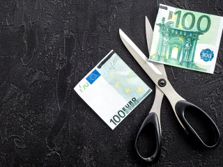 Decline of euro exchange rate. Scissors cut dollars banknote