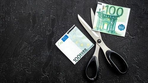 Decline of euro exchange rate. Scissors cut dollars banknote