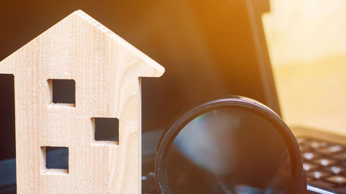 House and magnifying glass on the keyboard. The concept of housing search in the the Internet. Buy an apartment for sale online. House rent. Sell property. Affordable housing. Search for a hotel