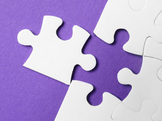 White puzzle with unfitting piece on purple background, flat lay