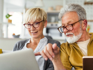 Happy romantic senior couple hugging and enjoying retirement at home