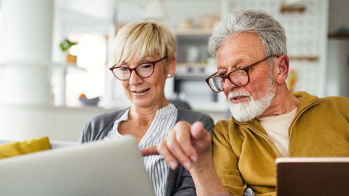 Happy romantic senior couple hugging and enjoying retirement at home