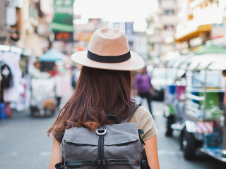 Back view Asian woman tourist backpacker travel in Khao San road