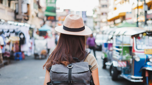 Back view Asian woman tourist backpacker travel in Khao San road