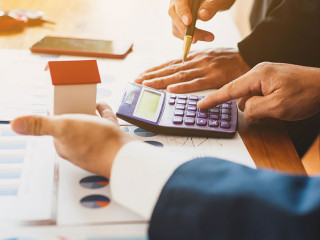 Real estate valuation concept. Businessman analyzes and calculat