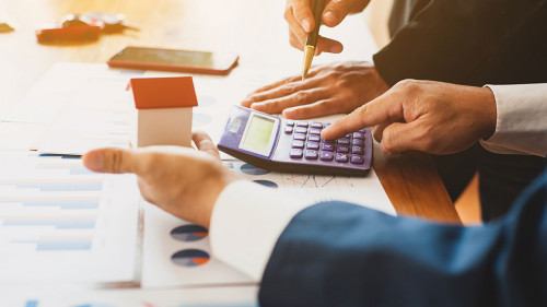 Real estate valuation concept. Businessman analyzes and calculat