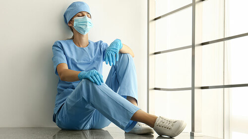 Exhausted doctor indoors. Stress of health care workers during C