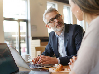 Sales meeting in modern open plan office space