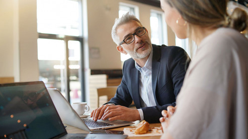 Sales meeting in modern open plan office space