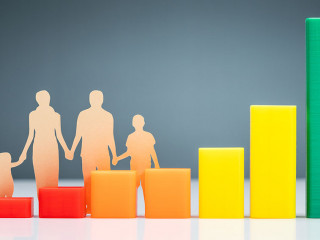 Family Cutout Paper Behind Chart On Desk