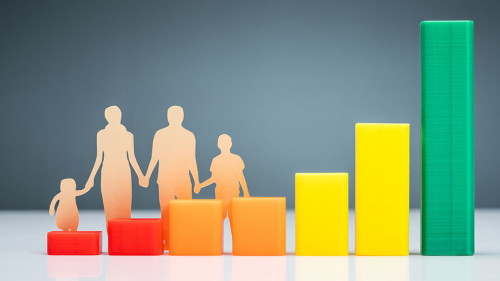 Family Cutout Paper Behind Chart On Desk