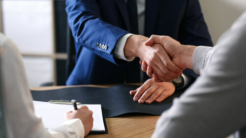 Male lawyer working with clients in office, closeup