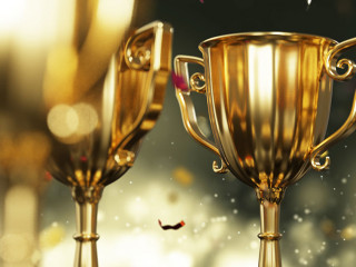close up golden trophy award with falling confetti. copy space f