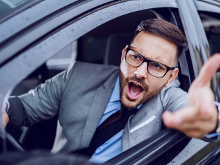 A sharp dressed man finding himself caught in a rush hour and sl