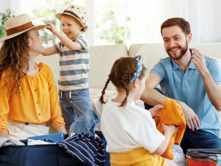 Playful family packing for holiday at home