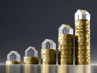 3d render: Rising stacks of Euro coins topped with model houses made from acrylic glass. Seamless dark background and reflections. Concept for extreme rise of housing prices.