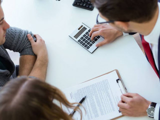 Business man explaining terms of contract to his clients in the