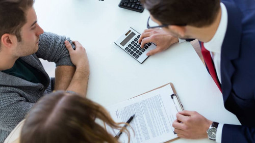 Business man explaining terms of contract to his clients in the