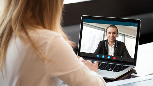 Business woman making video call to business partner via applica