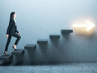 Young businesswoman moving up on stairs with arrow