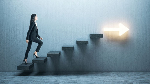 Young businesswoman moving up on stairs with arrow