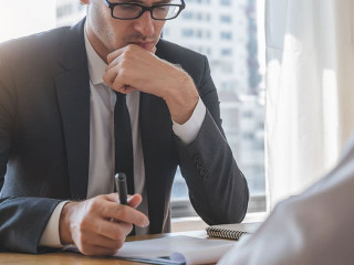 interviewer on the table asking question applicant in the office