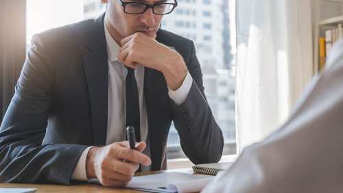 interviewer on the table asking question applicant in the office