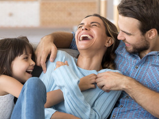 Family have fun daughter and daddy tickling mother