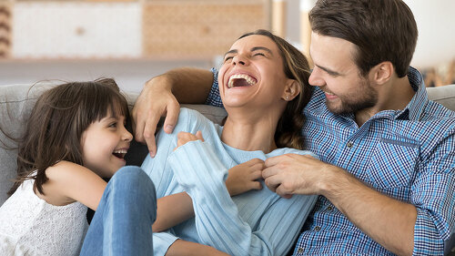Family have fun daughter and daddy tickling mother