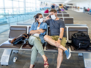 Coronavirus outbreak travel restrictions. Traveler with mask at