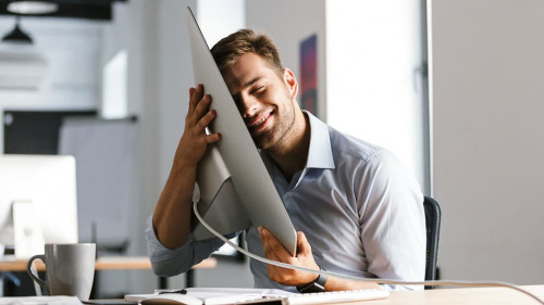 Pleased male manager having fun with computer