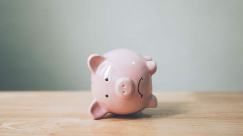 Piggy bank on wood table. Financial investment and save money concept