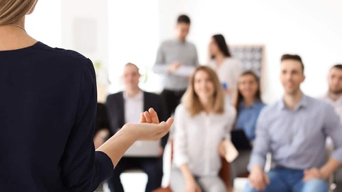 Female business trainer giving lecture in office
