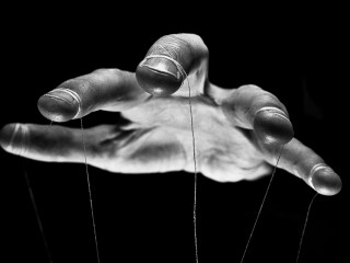 Eerie puppeteer hands controlling you. Manipulation concept