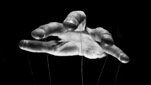 Eerie puppeteer hands controlling you. Manipulation concept