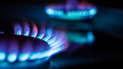 a hundred dollar bill on a gas burner with a burning fire on a b