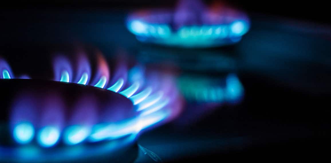a hundred dollar bill on a gas burner with a burning fire on a b