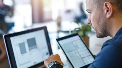 Business man looking and analyzing projects on his laptop comput