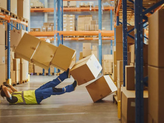 Shot of a Warehouse Worker Has Work Related Accident. He is Fall