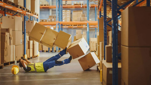 Shot of a Warehouse Worker Has Work Related Accident. He is Fall